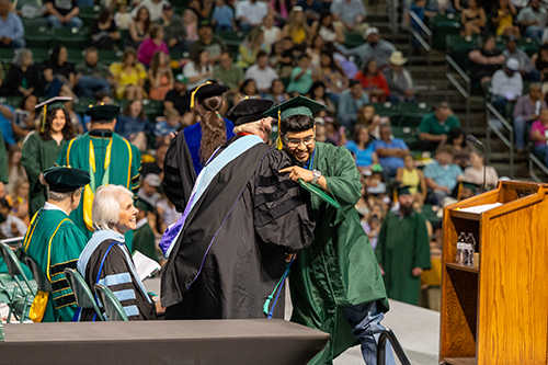 professor congratulating a graduate