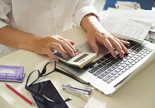 Accountant using a variety of tools at the desk