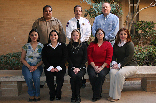 Group of MC BAS program graduates sitting on a bench for picture