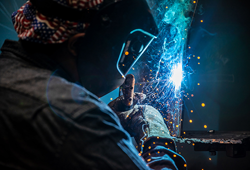 Students learning/practicing in MC welding shop