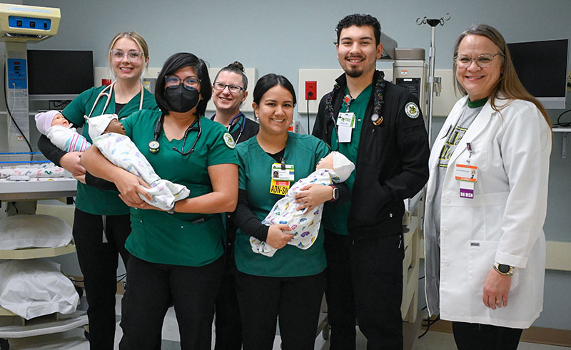 ADN students holding infant manequins