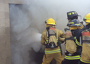 Fire Science students putting out a structure fire at the training facility