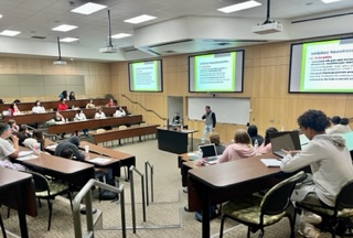 Teacher addressing students in lecture hall