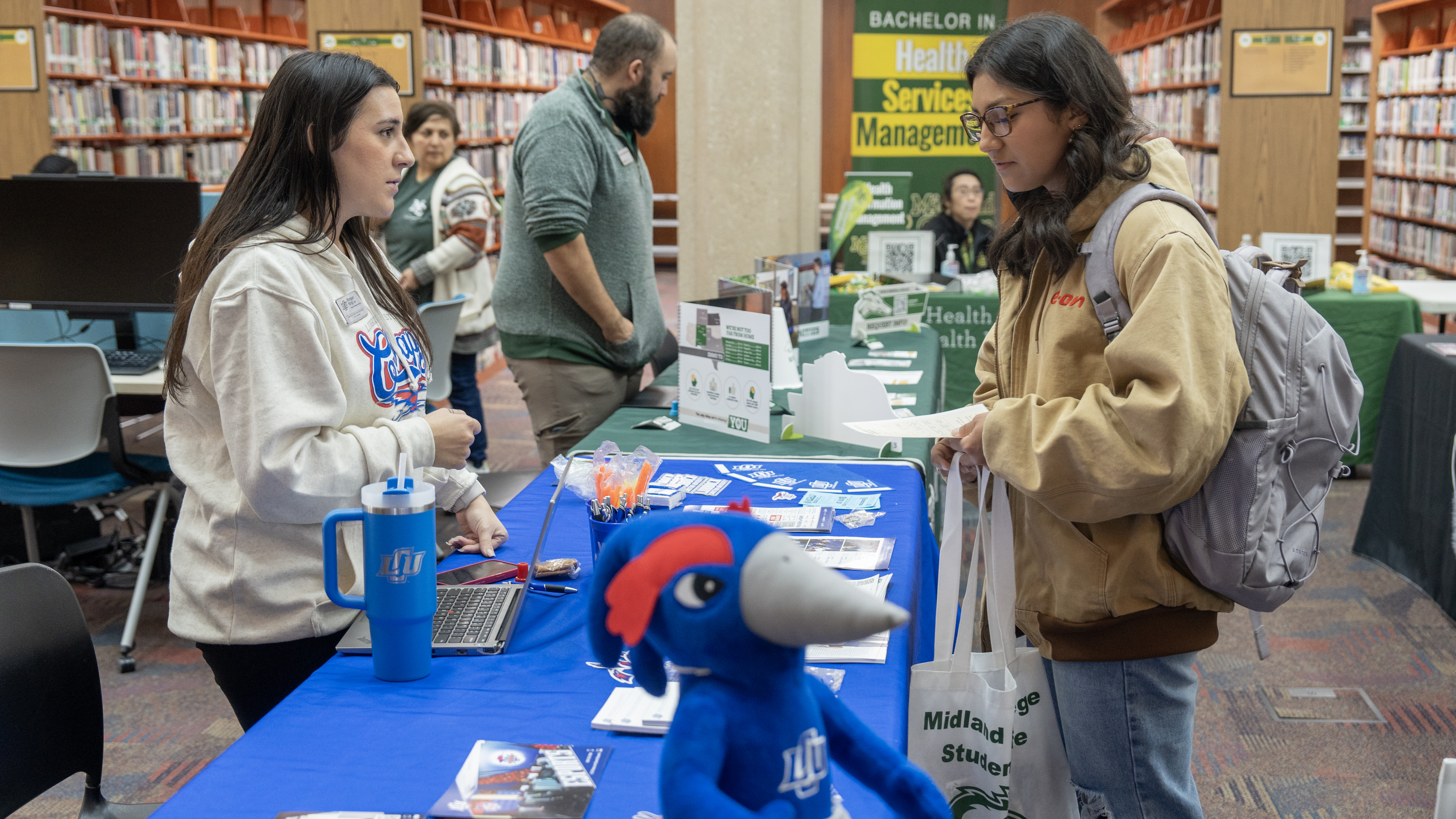 Transfer Fair 2025 student learning more about LCU