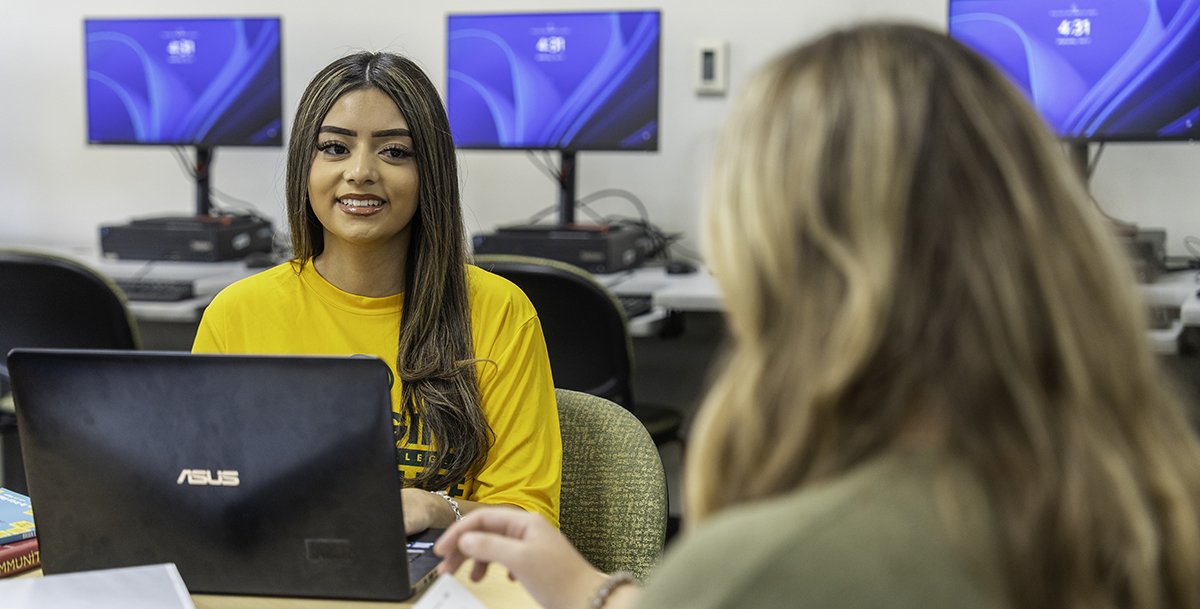 Two Midland College students wroking in the computer lab